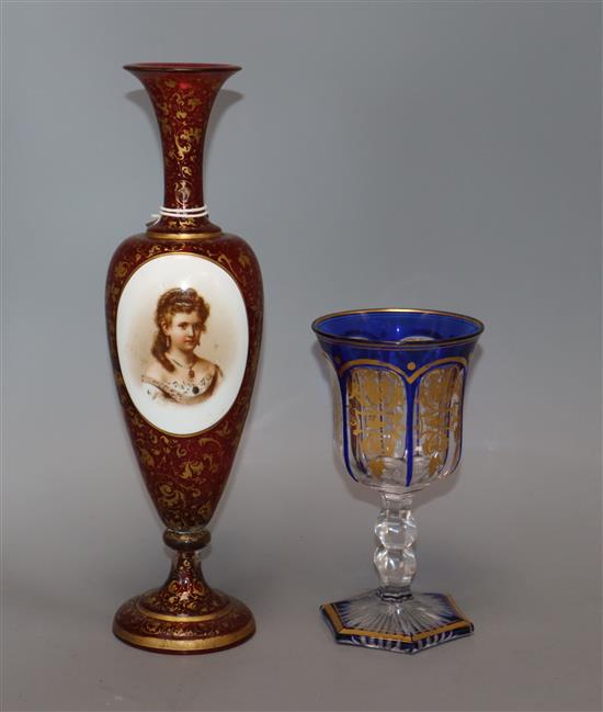 A Bohemian cut glass goblet and a cranberry glass vase with enamel portrait plaque tallest 30.5cm